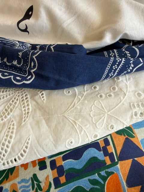 Close-up of various fabrics with different patterns and colors.