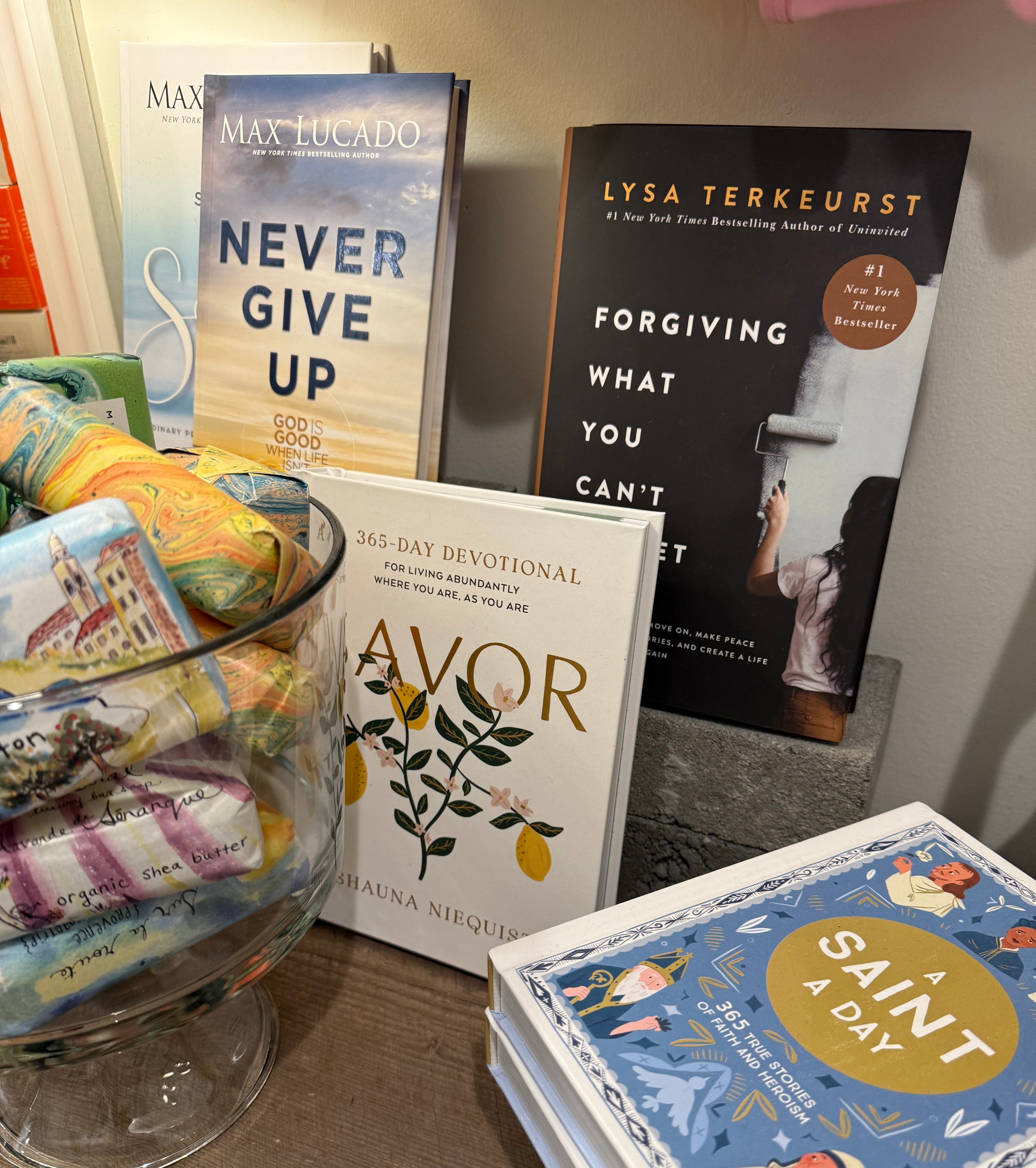 Books and a decorative glass bowl on a wooden surface